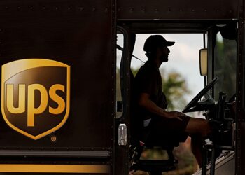 FILE PHOTO: A UPS delivery van is driven long a city street in Garden Grove, California, U.S., March 29, 2022.   REUTERS/Mike Blake/File Photo
