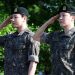 육군 현역 복무를 마치고 만기 전역한 그룹 방탄소년단(BTS)의 지민(오른쪽)과 정국이 11일 경기도 연천군 연천공설운동장에서 거수경례를 하고 있다. [로이터]