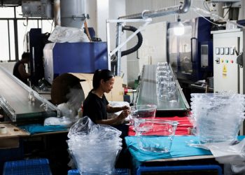 FILE PHOTO: An employees of Gstar Electronic Appliance Co., Ltd removes excess plastic from parts for kitchen product which came out of the automatic plastic injection molding machine in the factory in Ningbo, Zhejiang province, China May 19, 2025. REUTERS/Go Nakamura/File Photo/2025-06-11 18:07:41/
